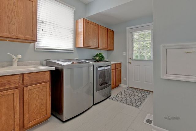 211 Washington Road Lake Forest, IL 60045 - Photo 9 of 26 a utility room with a sink a washer and dryer