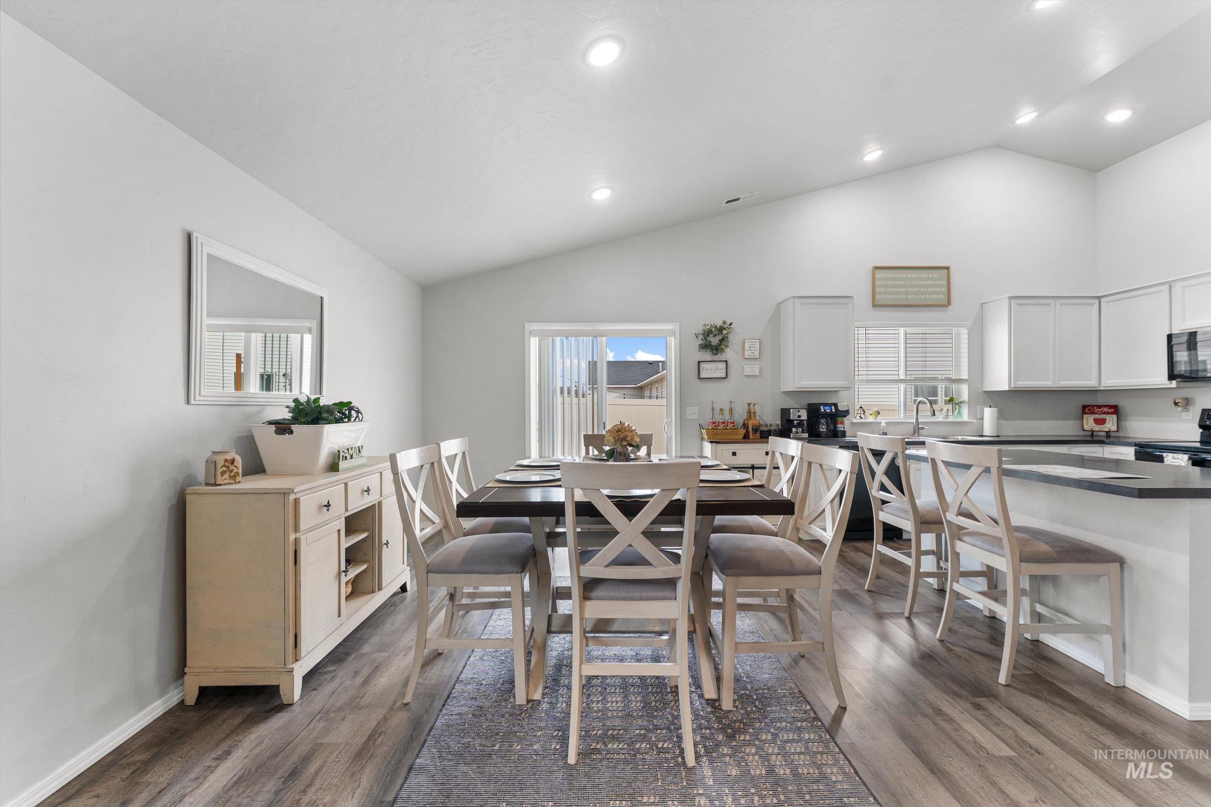 12798 Devonshire Street Caldwell, ID 83607 - Photo 11 of 42 Dining room with vaulted ceiling, dark wood-style flooring, recessed lighting, and plenty of natural light