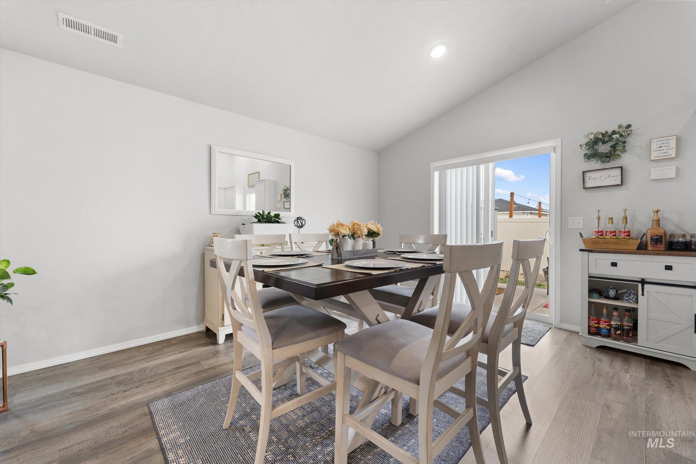 12798 Devonshire Street Caldwell, ID 83607 - Photo 12 of 42 Dining area with wood finished floors, vaulted ceiling, and recessed lighting