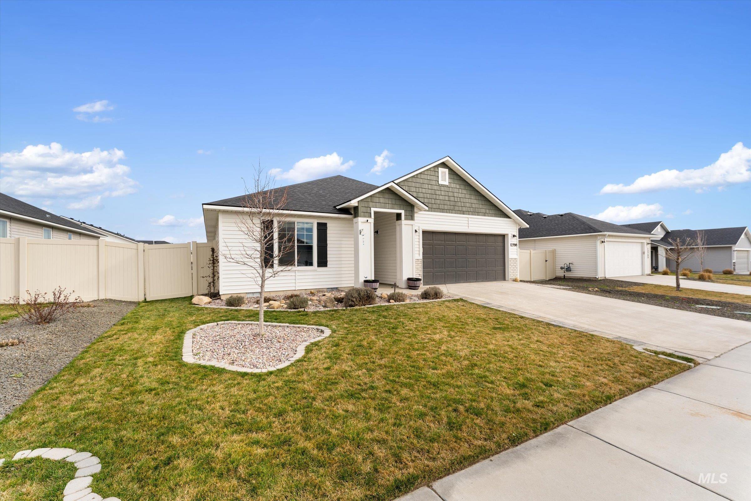 12798 Devonshire Street Caldwell, ID 83607 - Photo 2 of 42 View of front of home featuring a gate, concrete driveway, and a garage