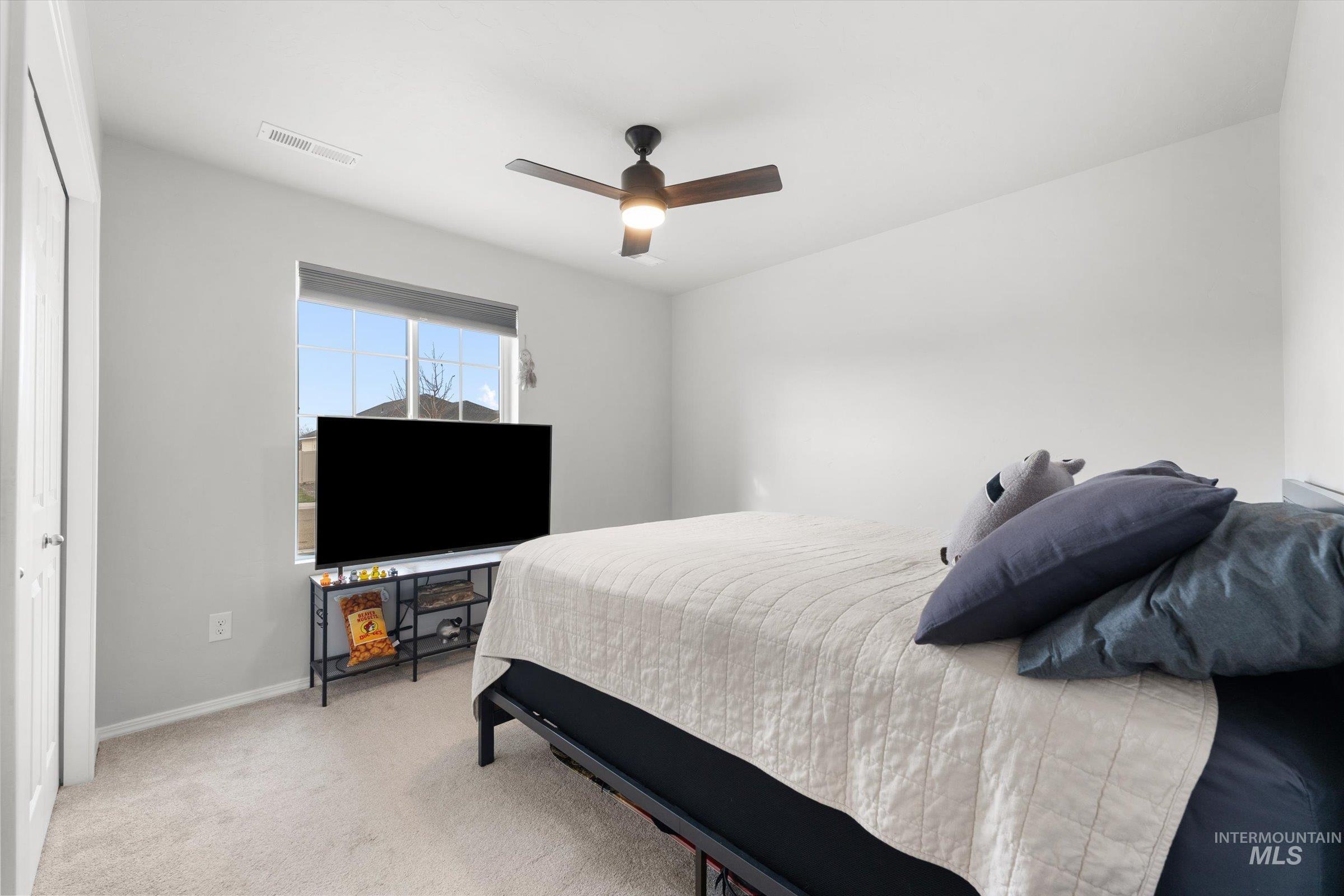 12798 Devonshire Street Caldwell, ID 83607 - Photo 23 of 42 Bedroom featuring light colored carpet and ceiling fan