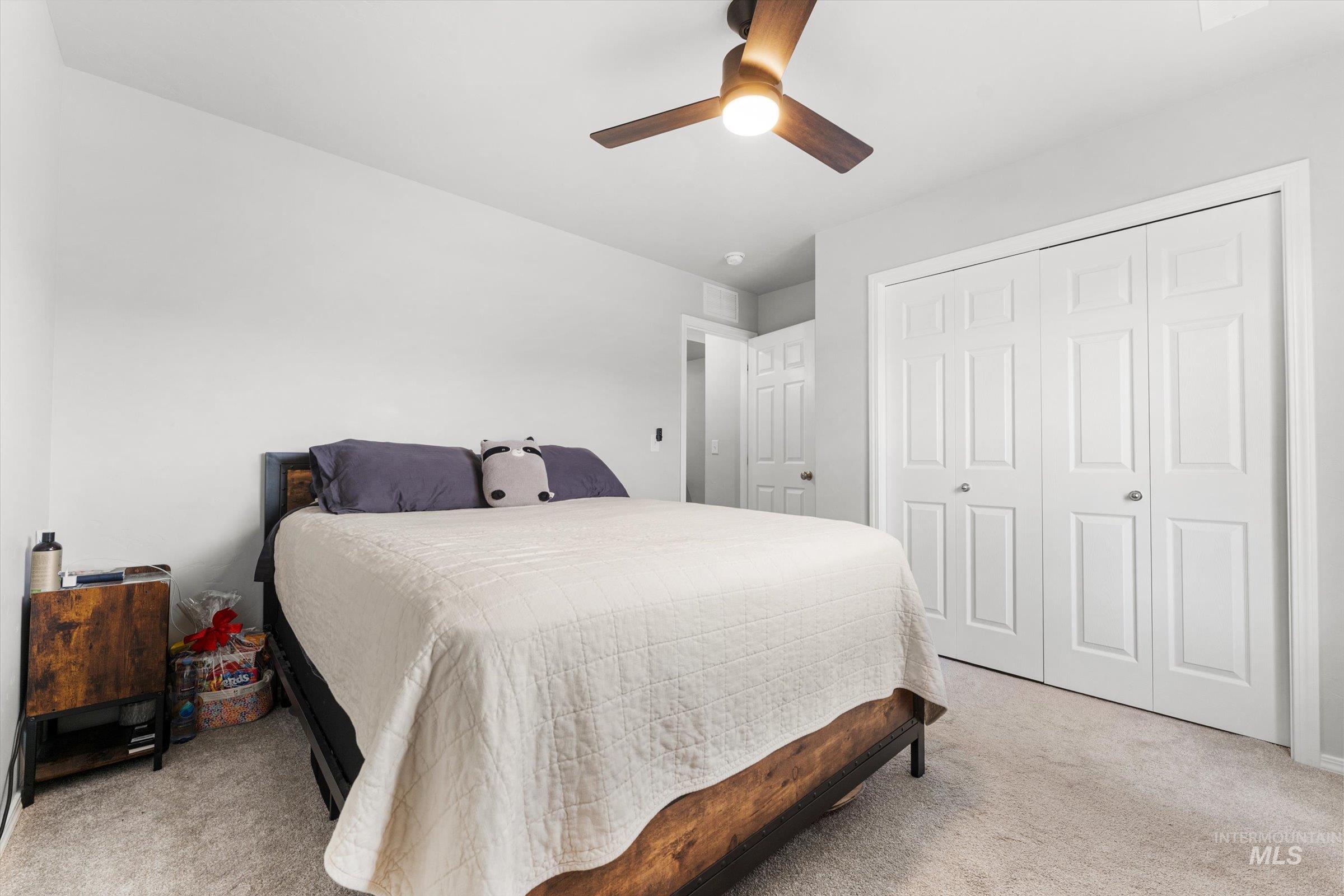 12798 Devonshire Street Caldwell, ID 83607 - Photo 24 of 42 Bedroom with light colored carpet, a ceiling fan, and a closet