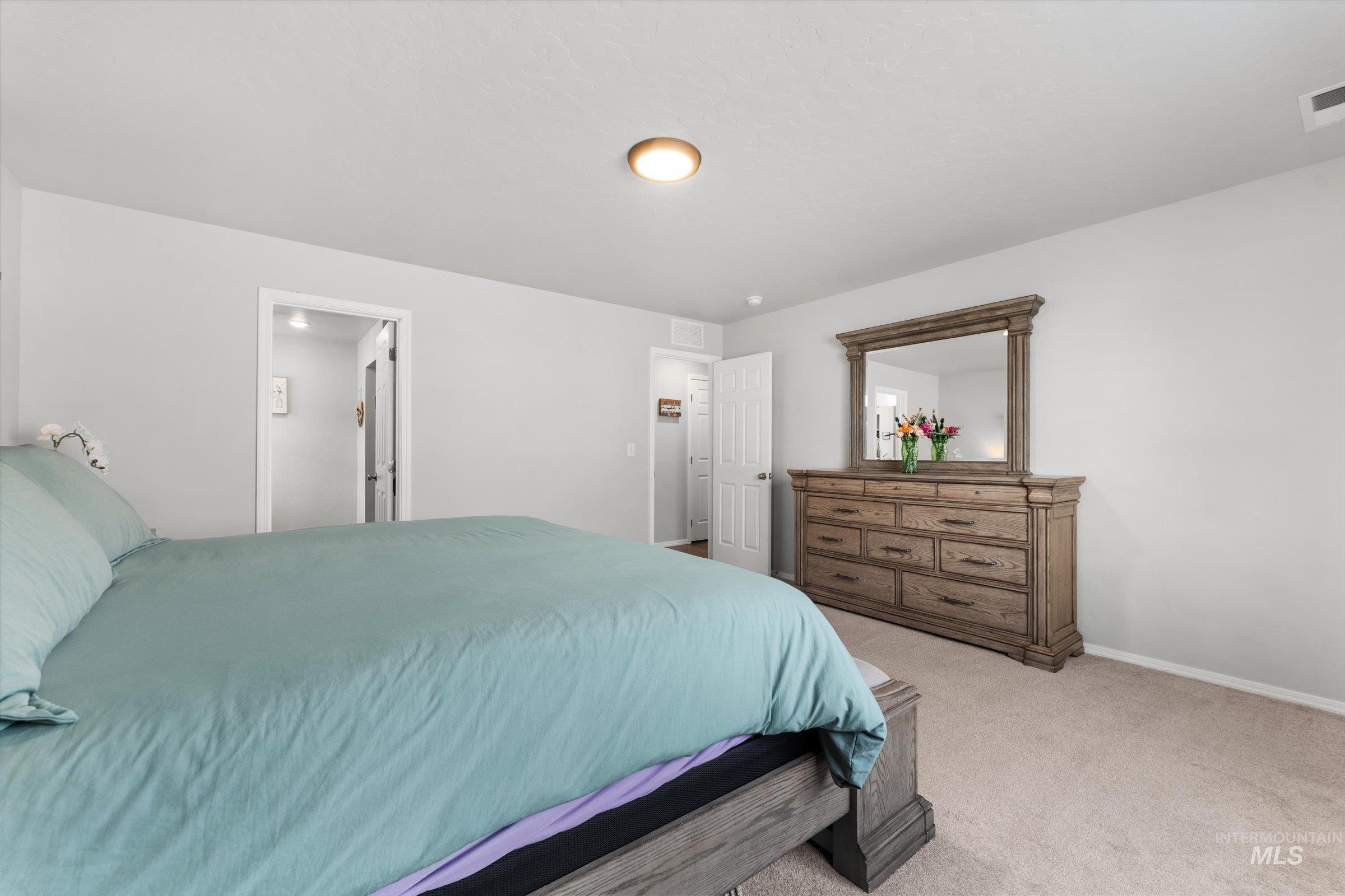 12798 Devonshire Street Caldwell, ID 83607 - Photo 26 of 42 Bedroom with light carpet and baseboards