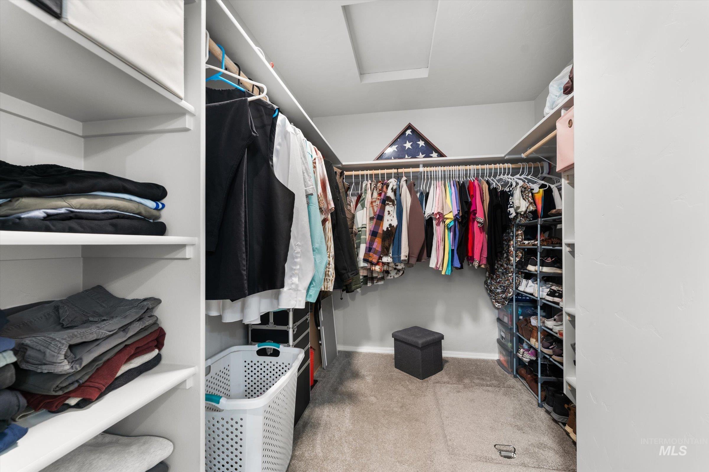 12798 Devonshire Street Caldwell, ID 83607 - Photo 29 of 42 Walk in closet with light colored carpet and attic access
