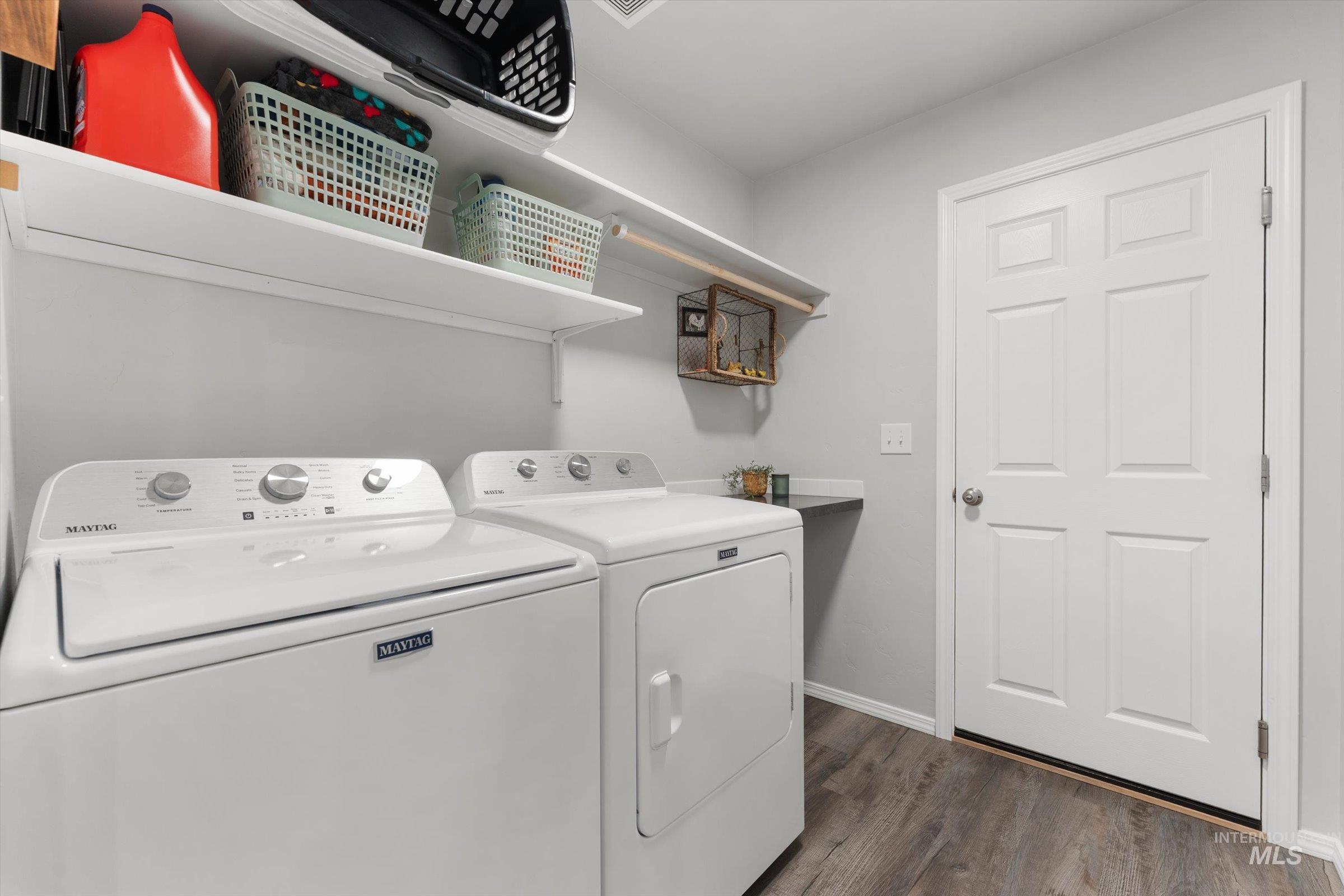 12798 Devonshire Street Caldwell, ID 83607 - Photo 30 of 42 Laundry room with washing machine and dryer and dark wood finished floors