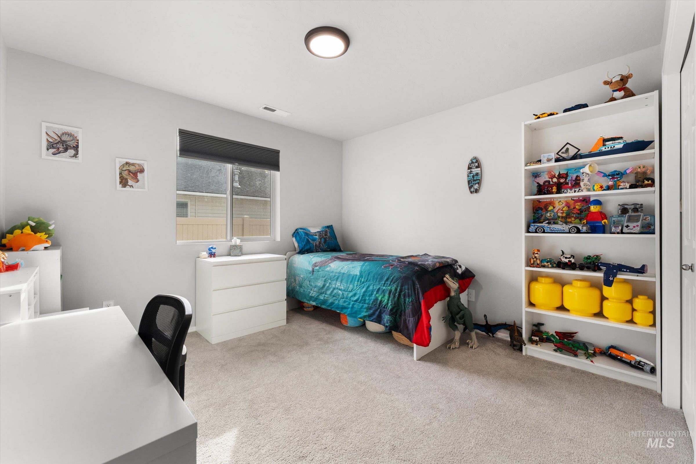 12798 Devonshire Street Caldwell, ID 83607 - Photo 31 of 42 Bedroom featuring light carpet and an office area