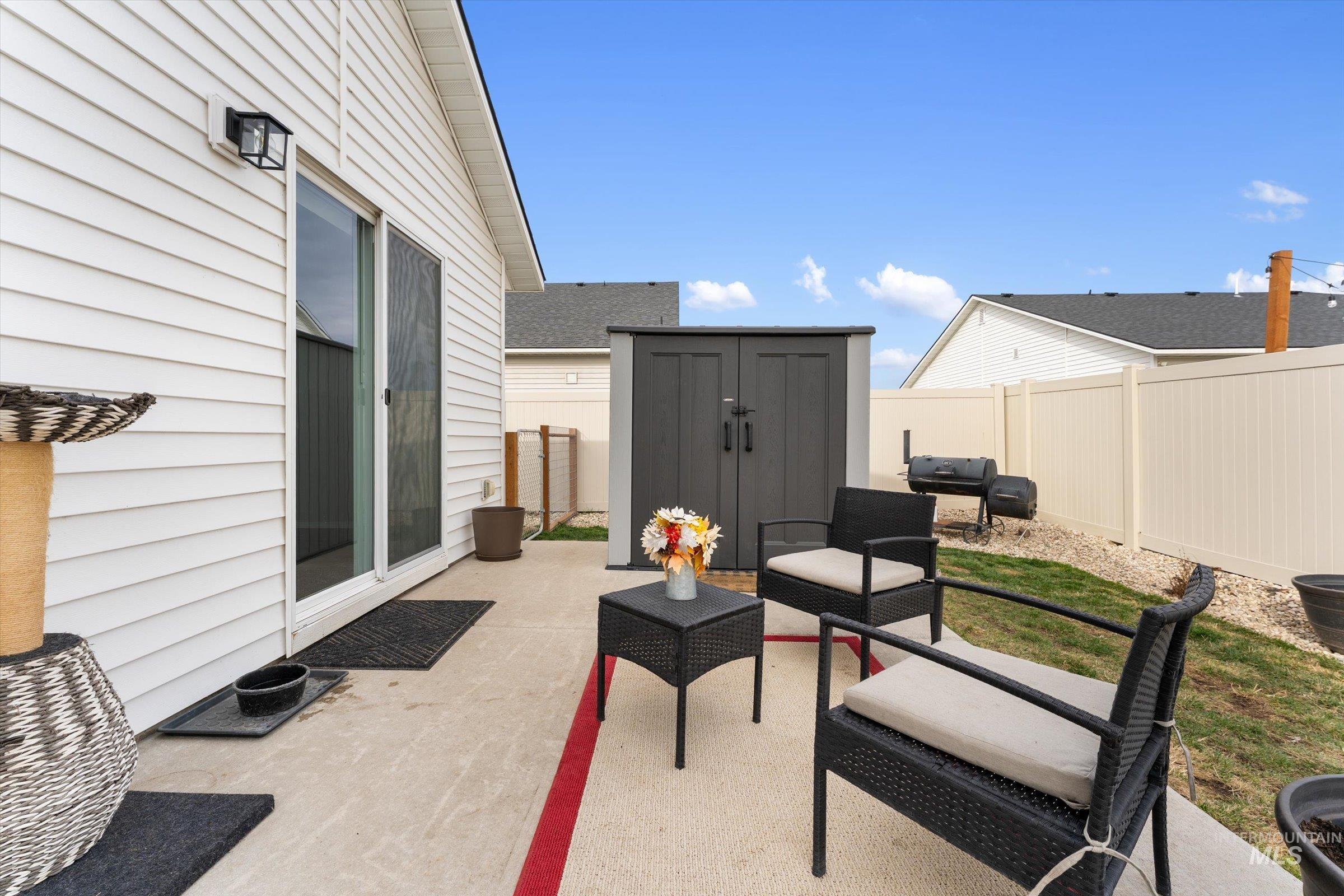 12798 Devonshire Street Caldwell, ID 83607 - Photo 34 of 42 Fenced backyard with a patio, a storage shed, and area for grilling