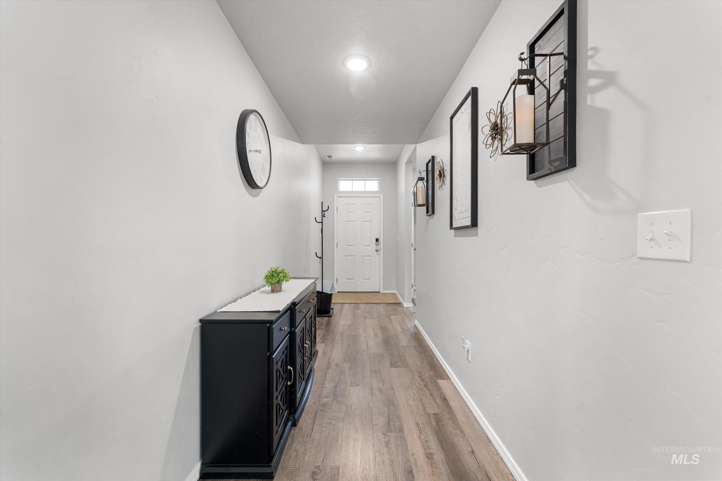 12798 Devonshire Street Caldwell, ID 83607 - Photo 4 of 42 Corridor with baseboards and light wood finished floors