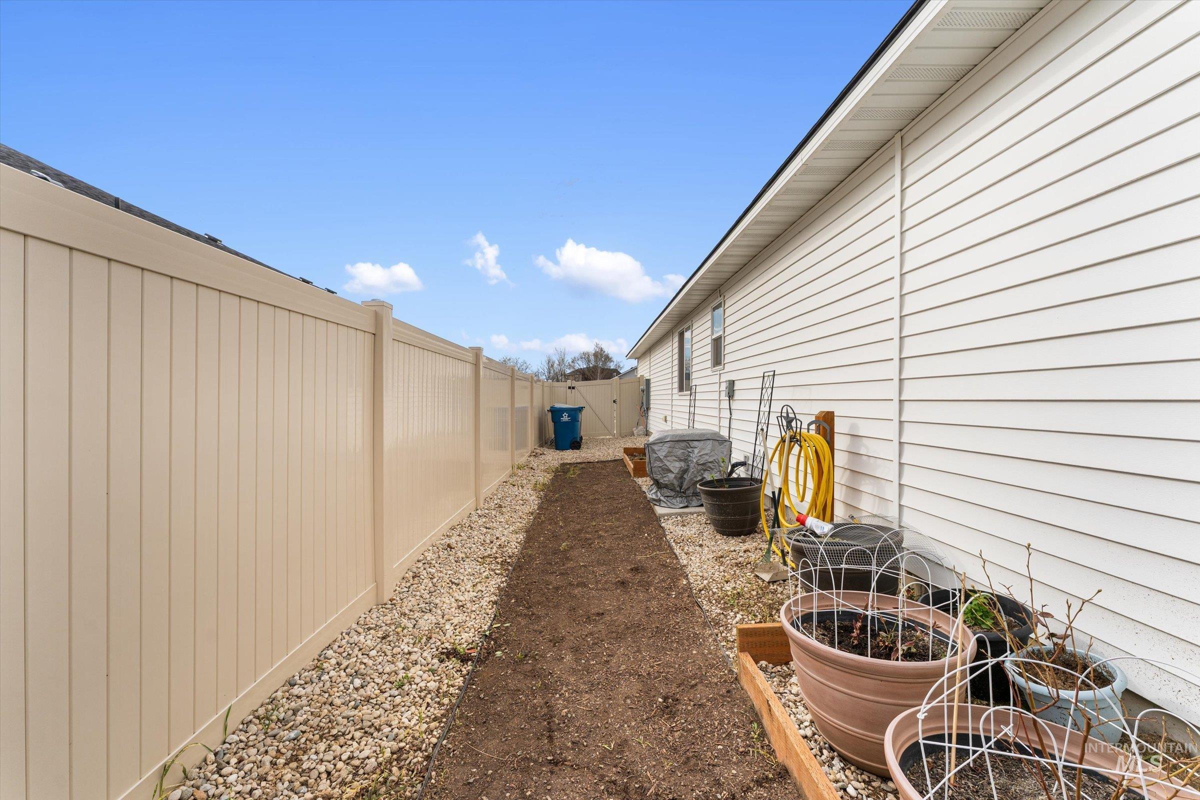 12798 Devonshire Street Caldwell, ID 83607 - Photo 40 of 42 Fenced backyard featuring a gate and a garden
