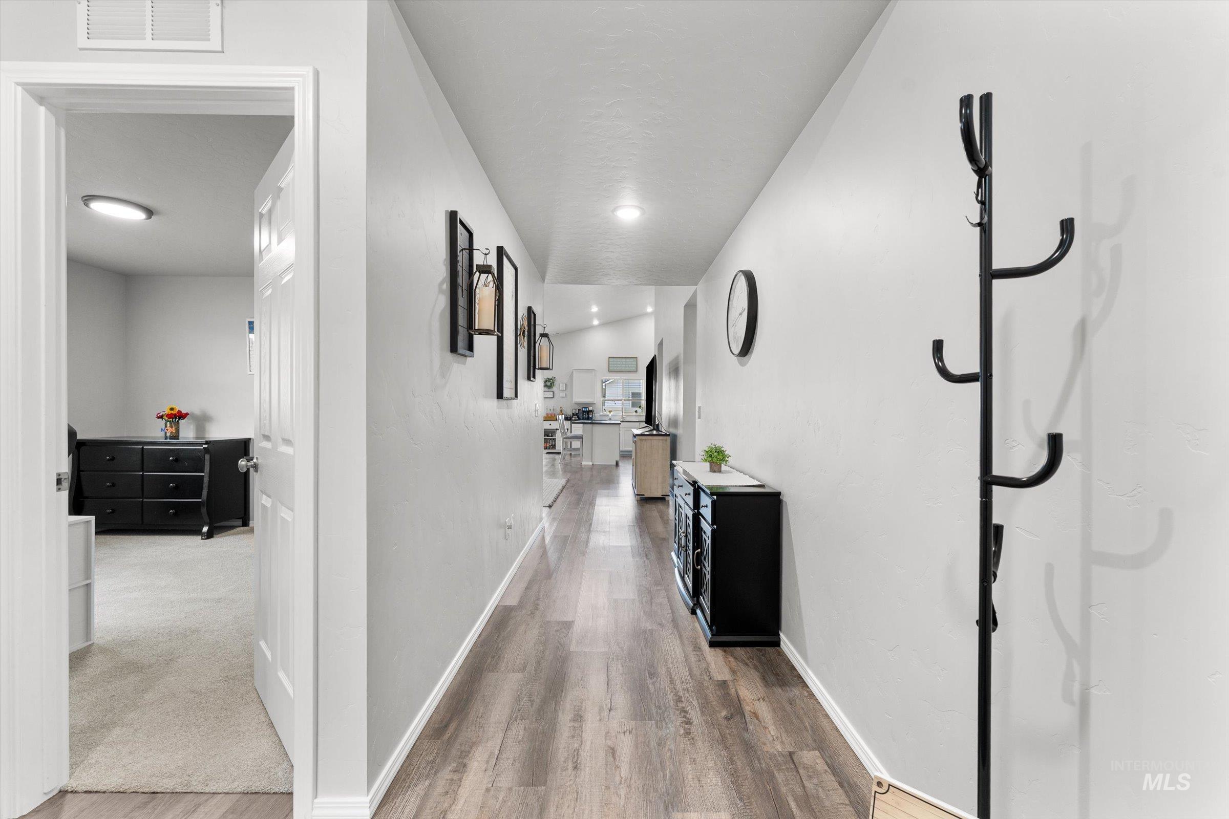 12798 Devonshire Street Caldwell, ID 83607 - Photo 5 of 42 Hallway with baseboards and light wood-style floors