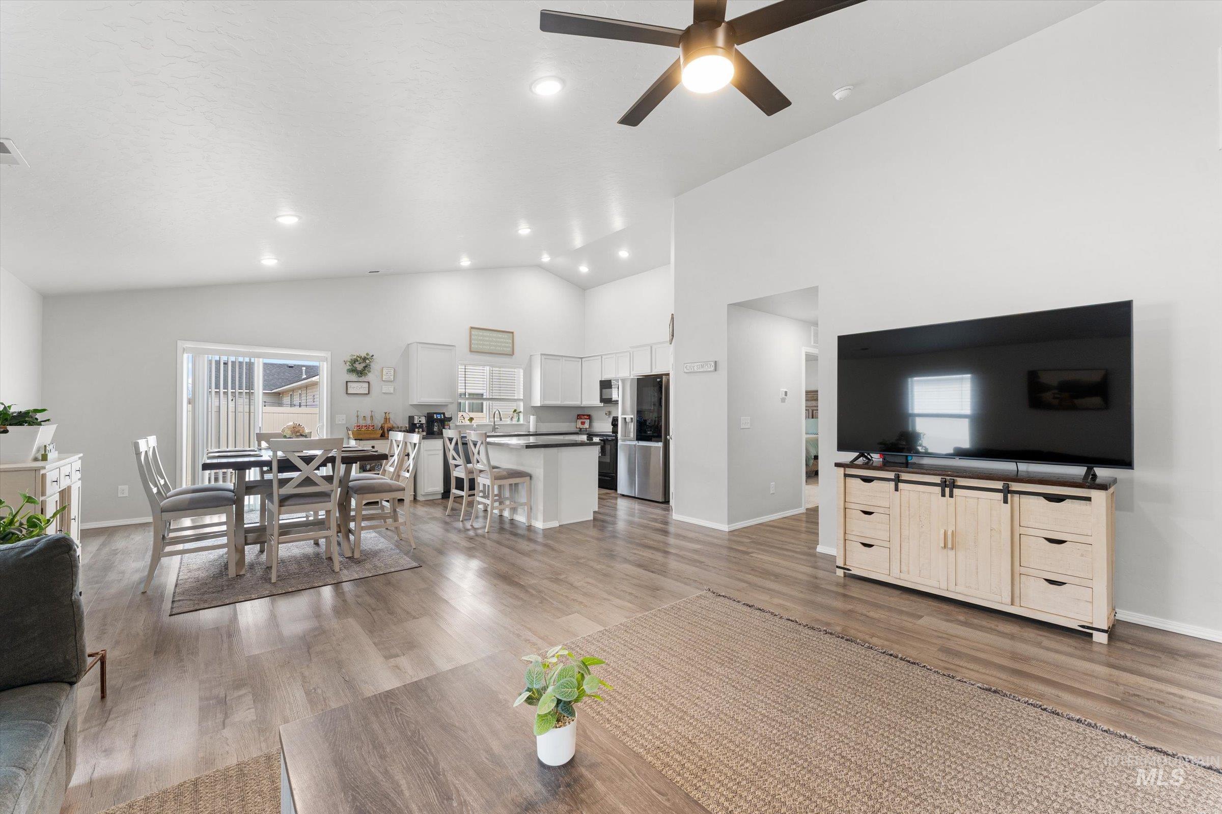 12798 Devonshire Street Caldwell, ID 83607 - Photo 7 of 42 Living room with a ceiling fan, light wood-style flooring, vaulted ceiling, and recessed lighting