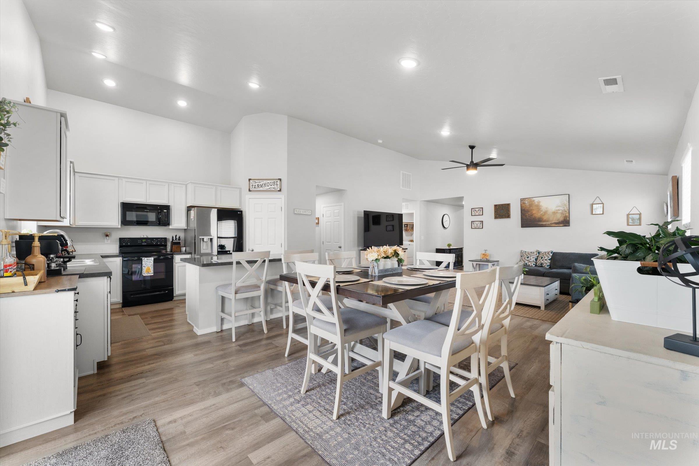 12798 Devonshire Street Caldwell, ID 83607 - Photo 8 of 42 Dining area featuring ceiling fan, light wood-style flooring, lofted ceiling, and recessed lighting