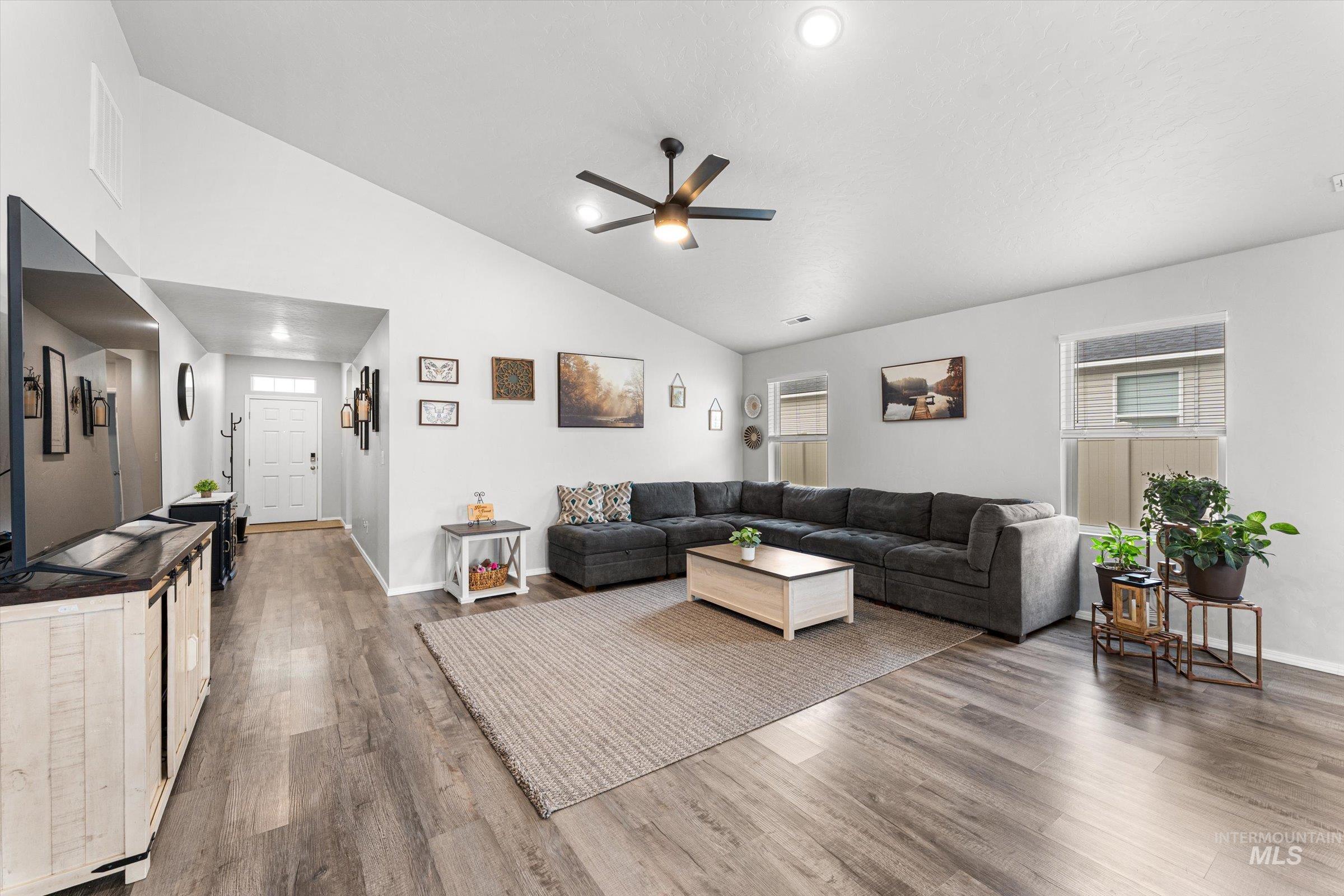 12798 Devonshire Street Caldwell, ID 83607 - Photo 9 of 42 Living area featuring ceiling fan, wood finished floors, lofted ceiling, and recessed lighting