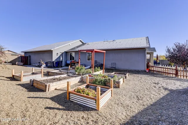 a view of a house with backyard porch and sitting area