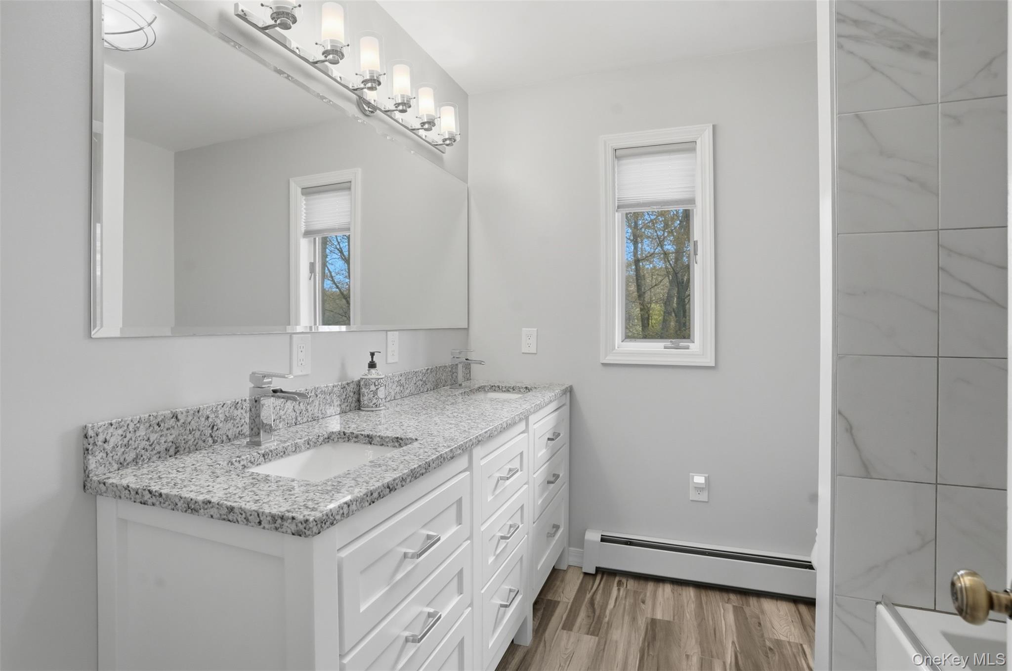 8 Division Road Wurtsboro, NY 12790 - Photo 41 of 50 Upper-level 2nd bathroom. Double Sinks. Granite CT. tub/Shower. Tiled floors.