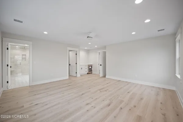 a bathroom with a double vanity sink toilet mirror and shower