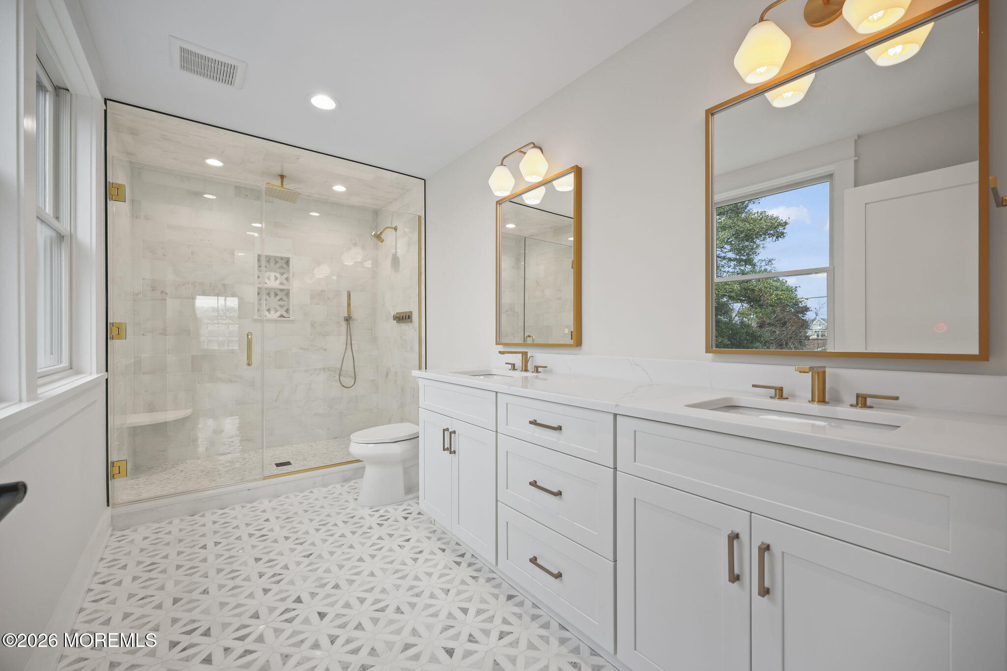 217 Pitney Avenue Spring Lake, NJ 07762 - Photo 5 of 18 a bathroom with a double vanity sink toilet mirror and shower