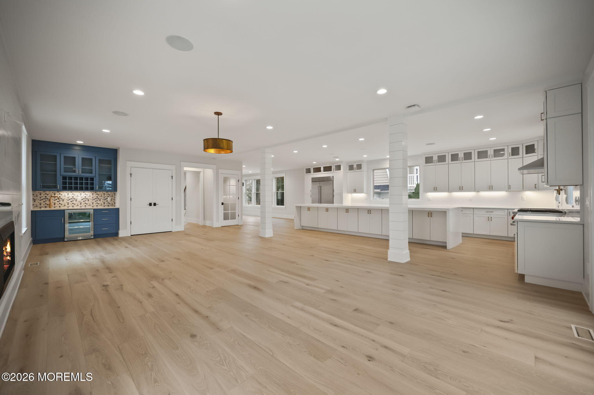 217 Pitney Avenue Spring Lake, NJ 07762 - Photo 8 of 18 a view of a kitchen with white cabinets and wooden floor