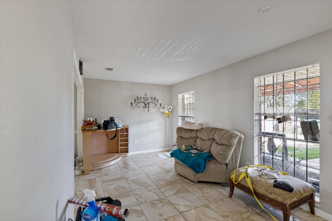 4709 Baton Rouge Street Houston, TX 77028 - Photo 13 of 16 Tiled flooring and large windows create a bright foundation for this living space.