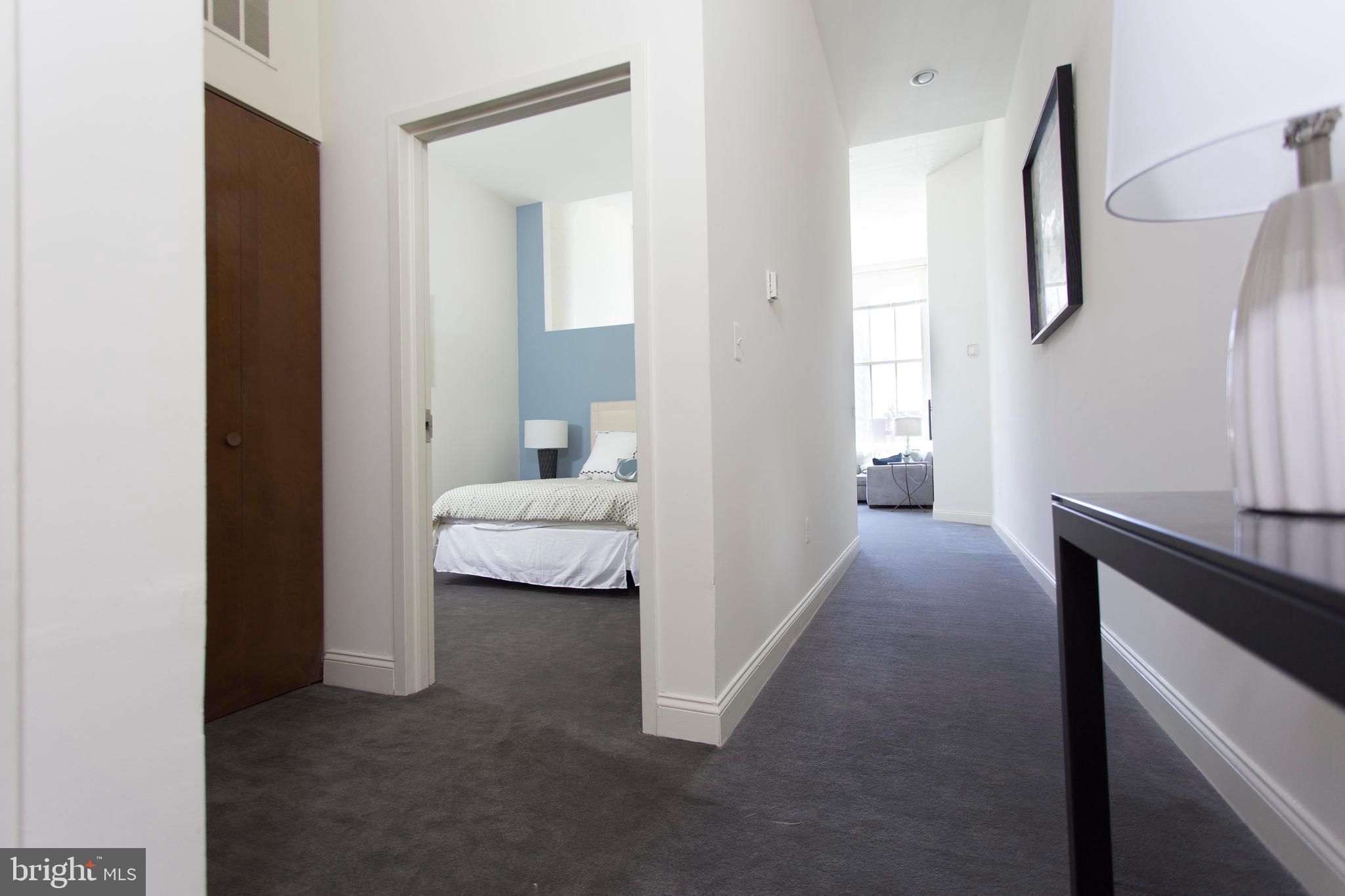 2121-41 Market Street, Unit 506 Philadelphia, PA 19103 - Photo 9 of 24 a view of bedroom with furniture and wooden floor