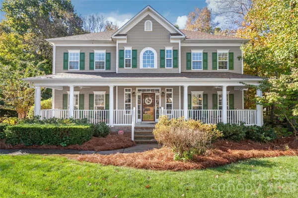 a front view of a house with a yard and porch