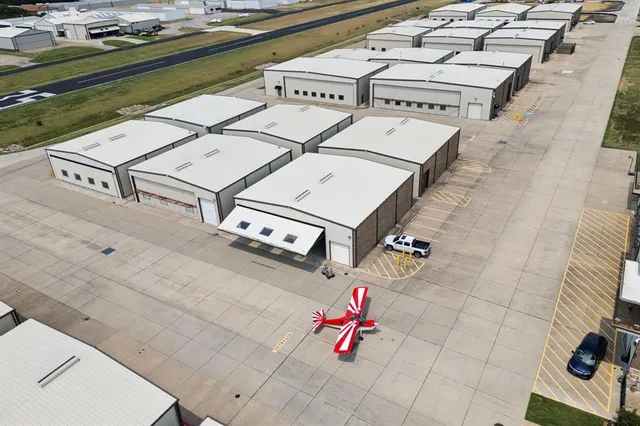 a view of a patio with couches and table and chairs with wooden floor
