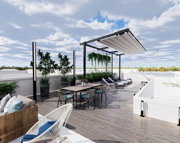 a living room with patio furniture and a garden