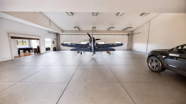 a living room with furniture flat screen tv and a large window