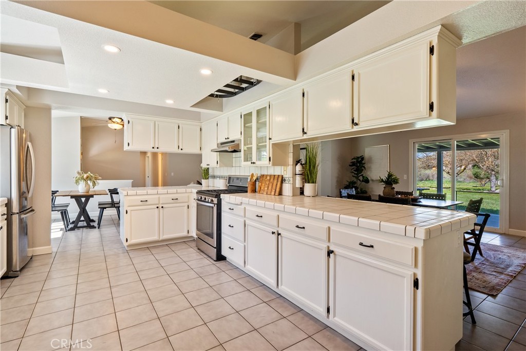 6446 Windmill Place Paso Robles, CA 93446 - Photo 13 of 44 a kitchen with cabinets and chairs