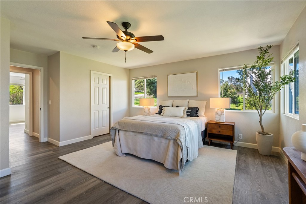 6446 Windmill Place Paso Robles, CA 93446 - Photo 15 of 44 a spacious bedroom with a bed a couch and potted plant