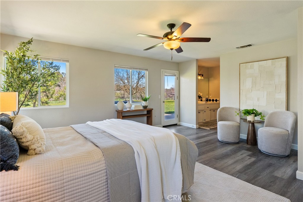 6446 Windmill Place Paso Robles, CA 93446 - Photo 16 of 44 a bedroom with a balcony a bed and a chandelier