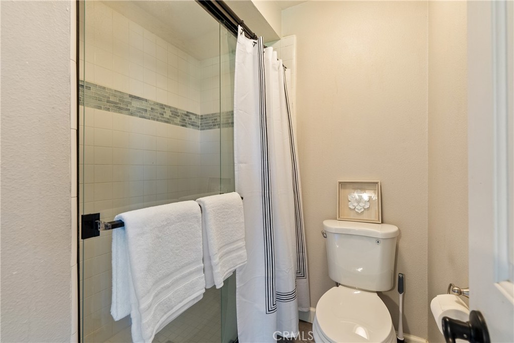6446 Windmill Place Paso Robles, CA 93446 - Photo 18 of 44 a white toilet sitting next to a bathroom sink