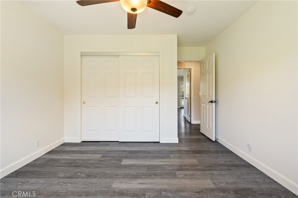 6446 Windmill Place Paso Robles, CA 93446 - Photo 19 of 44 an empty room with wooden floor cabinet and ceiling fan