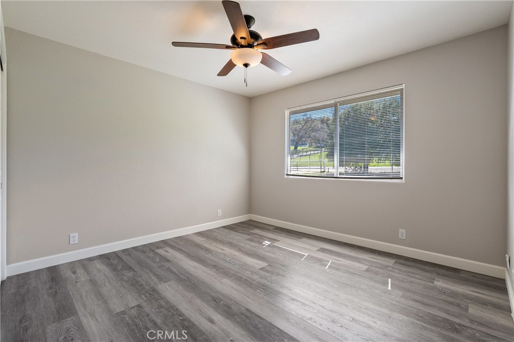 6446 Windmill Place Paso Robles, CA 93446 - Photo 20 of 44 a view of an empty room with a window and a ceiling fan