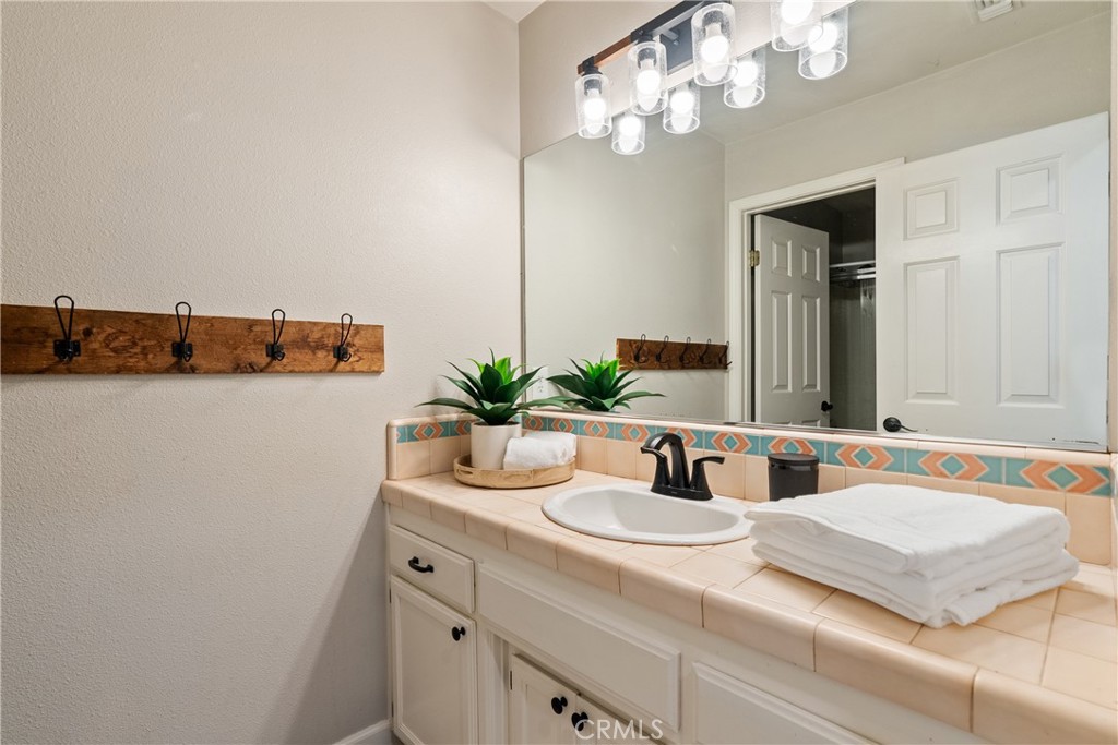 6446 Windmill Place Paso Robles, CA 93446 - Photo 21 of 44 a bathroom with a granite countertop sink and a mirror