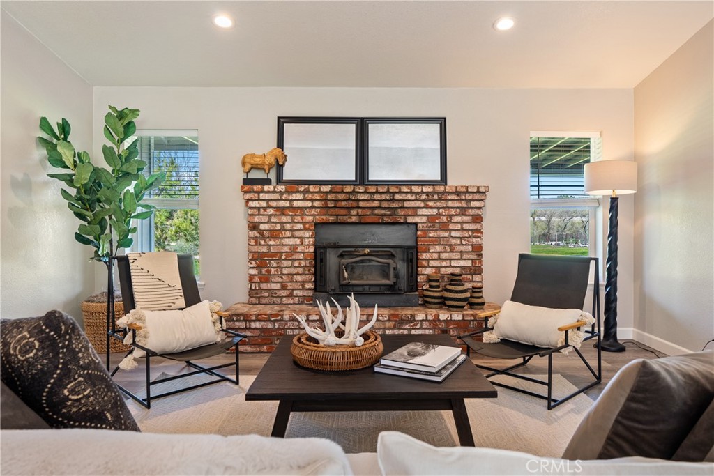 6446 Windmill Place Paso Robles, CA 93446 - Photo 6 of 44 a living room with furniture potted plant and a fireplace
