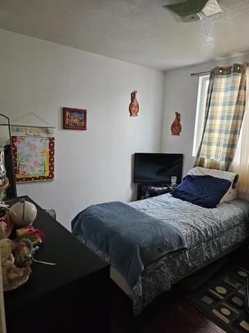 a bedroom with a bed and a window