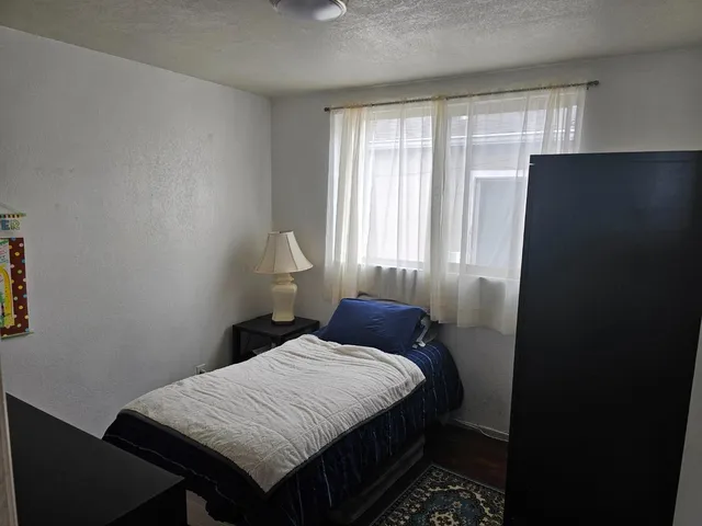 a bedroom with a bed and a window