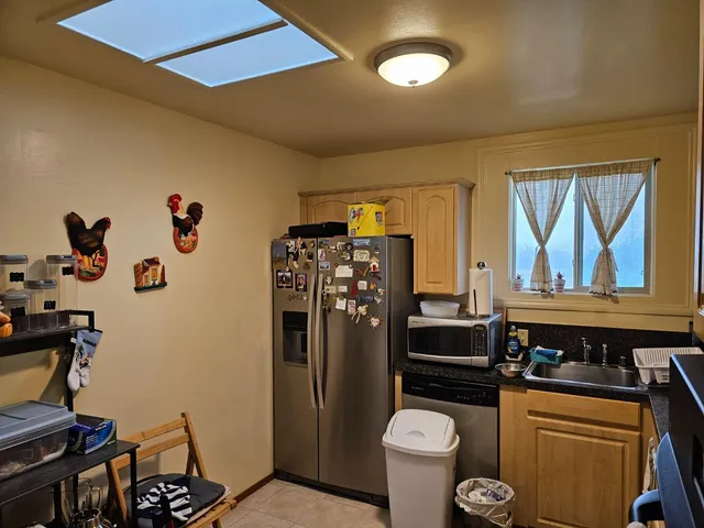 a kitchen with a refrigerator and a stove