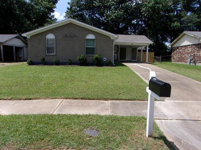 a front view of house with yard and green space