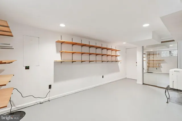 a room with a wooden floor and white walls