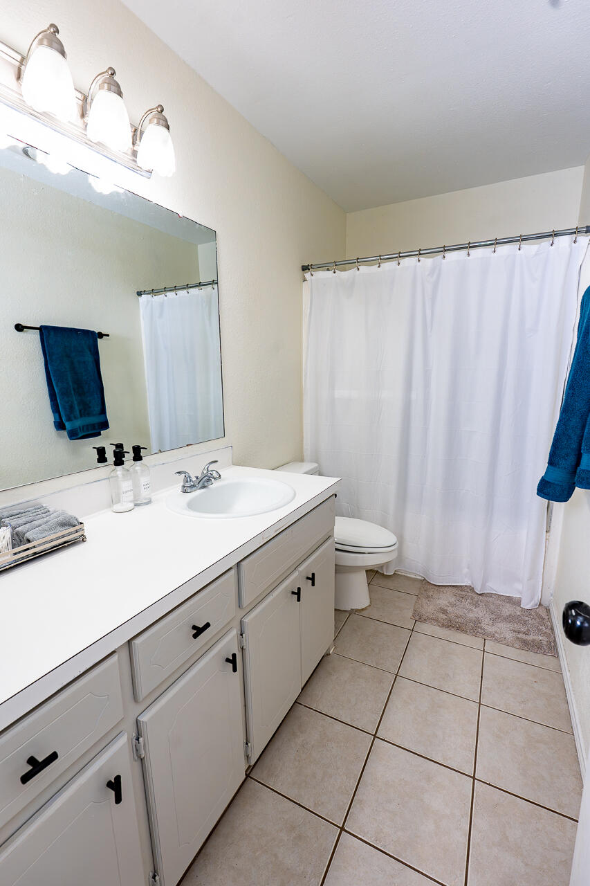1016 Ironton Avenue Lubbock, TX 79416 - Photo 13 of 29 a bathroom with a sink a toilet and a mirror