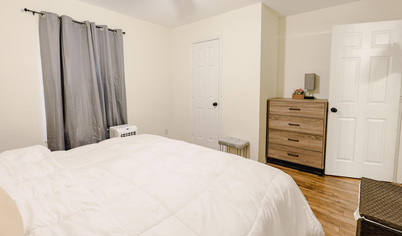 1016 Ironton Avenue Lubbock, TX 79416 - Photo 15 of 29 a bedroom with a bed and wooden floor