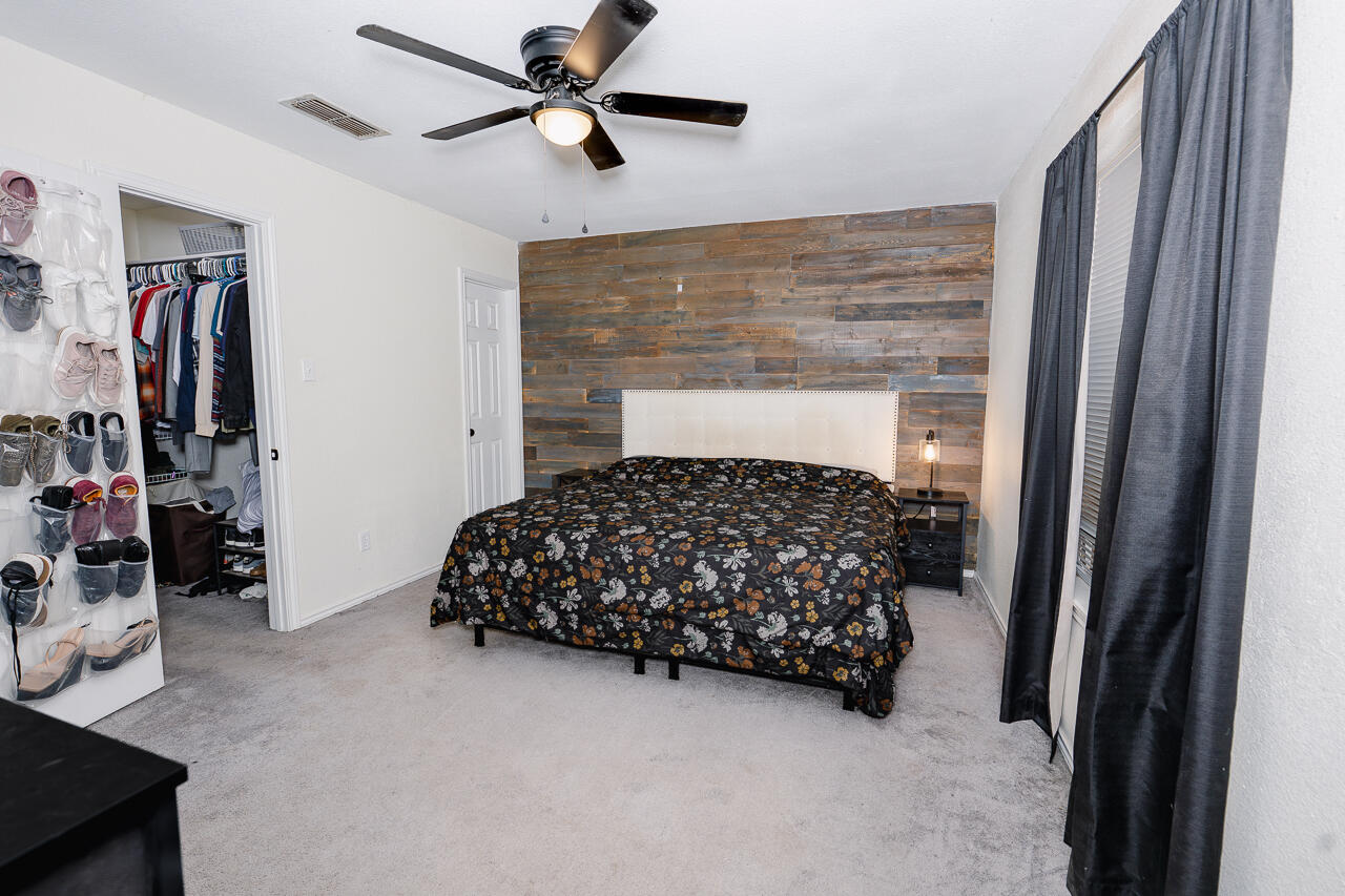 1016 Ironton Avenue Lubbock, TX 79416 - Photo 16 of 29 a bedroom with a bed and a walk in closet