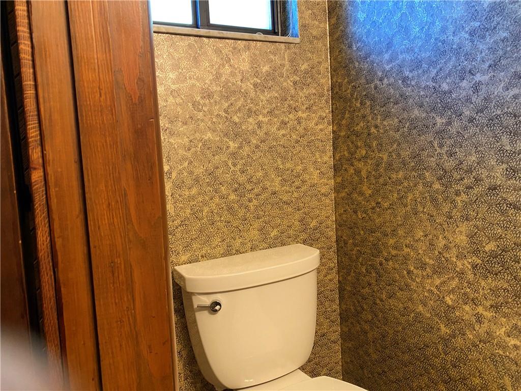 7919 Mt Carmel Road Verona, PA 15147 - Photo 18 of 38 a white toilet sitting next to a shower curtain