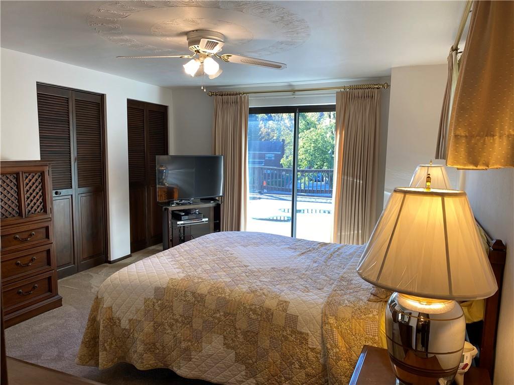 7919 Mt Carmel Road Verona, PA 15147 - Photo 20 of 38 a bedroom with a bed and a chandelier