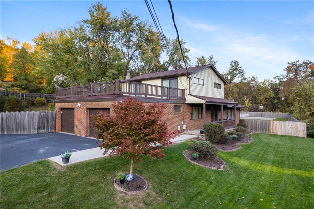 7919 Mt Carmel Road Verona, PA 15147 - Photo 2 of 38 a front view of a house with garden