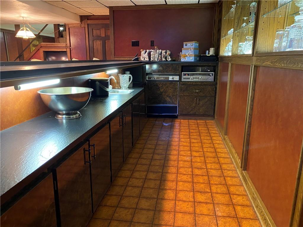 7919 Mt Carmel Road Verona, PA 15147 - Photo 30 of 38 a kitchen with granite countertop a sink a stove and cabinets