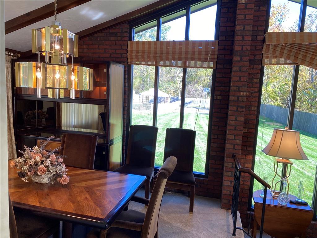 7919 Mt Carmel Road Verona, PA 15147 - Photo 10 of 38 a view of a dining room with furniture a chandelier and wooden floor