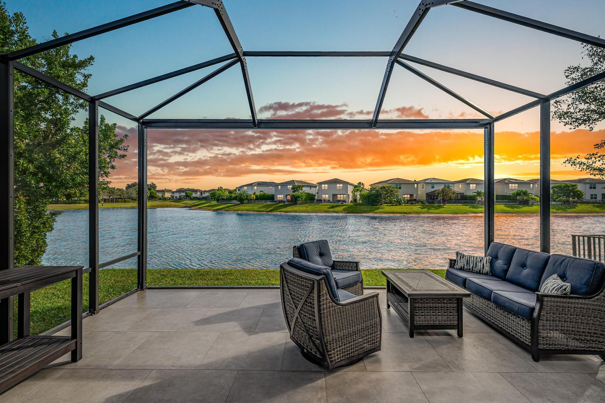 a view of swimming pool with a couches in a patio